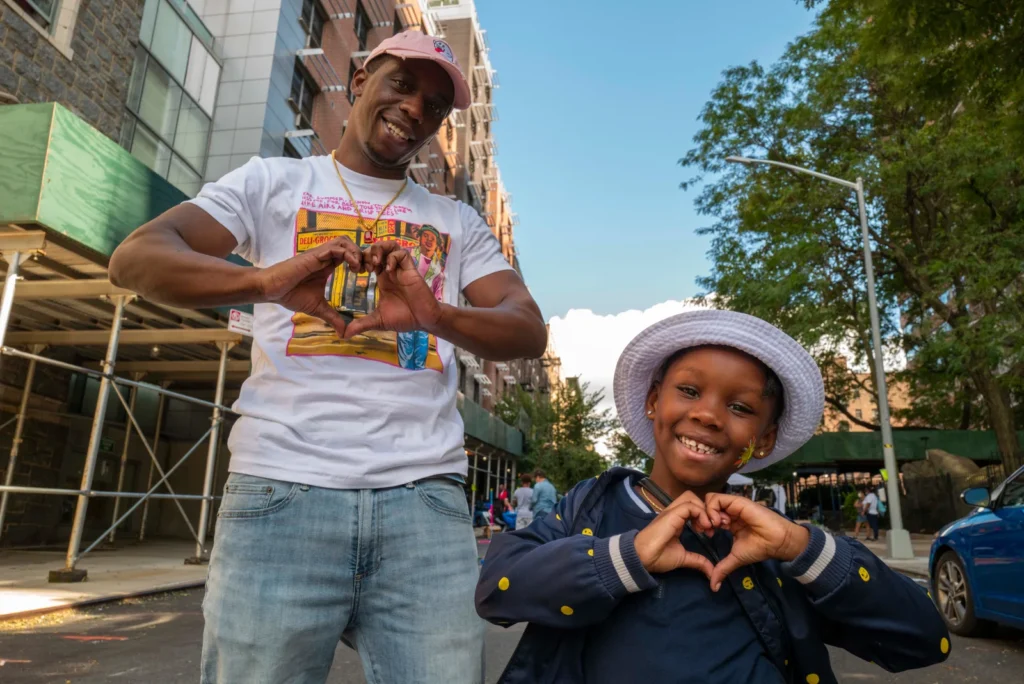 A parent and child enjoying a community event